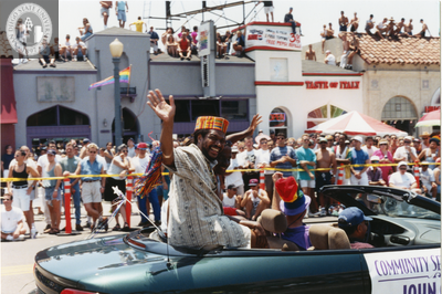 Person waving to crowd at Pride parade, 1998