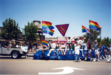 Participants on The Center float waving to the crowd at Pride parade, 1998