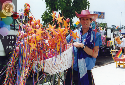 Individual holding basket of toy wands at Pride parade