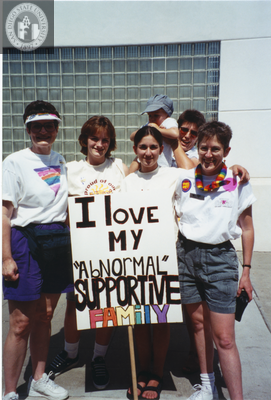Karen Marshall with 'I love my ... family' sign at Pride parade