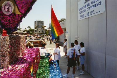 Participants standing next to The Center's float at Pride parade, 1998