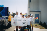 "Front Desk Team" banner at Pride parade, 1996