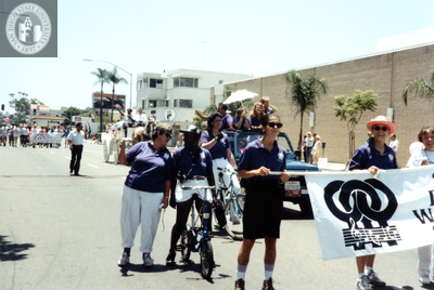 Marchers carrying San Diego Women's Chorus banner at Pride parade, 1992
