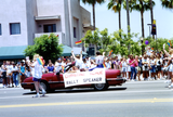 Christine Kehoe riding on back of convertible in Pride parade, 1992