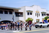 Marchers in police uniforms and civilian clothes walking Pride parade route, 1992