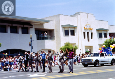 Marchers in police uniforms and civilian clothes walking Pride parade route, 1992