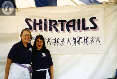 Sheila Clark with Judy Reif in front of Shirtails booth at Pride festival, 1992