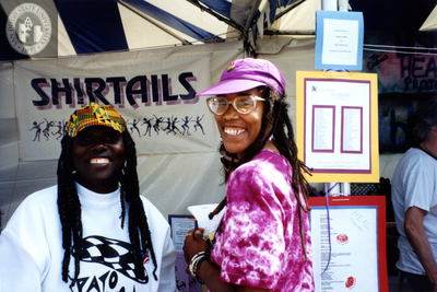 Makeda Dread in front of Shirtails booth at Pride festival, 1992