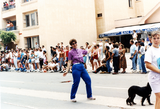 Marcher poses while walking Pride parade route, 1995