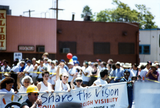 Sheila Clark, Judy Reif and others carry a banner at Pride parade, 1997