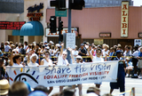 Sheila Clark and Judy Reif carry a banner at Pride parade, 1997