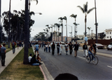 Parade marchers behind person on bicycle in Pride parade, 1982