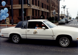 "The Loft" sign on white car at Pride parade, 1982