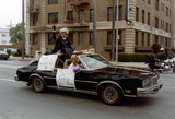 Miss Gay San Diego, Tiffany, sitting on black car in Pride parade, 1982