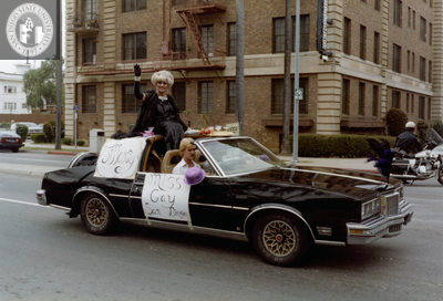 Miss Gay San Diego, Tiffany, sitting on black car in Pride parade, 1982
