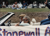Gray-haired couple in front of car with "Stonewall" on it