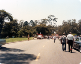People in staging area, waiting for parade to begin, 1984