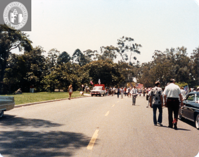 People in staging area, waiting for parade to begin, 1984