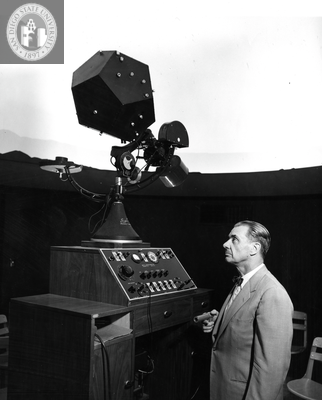Clifford Smith operates a planetarium projector